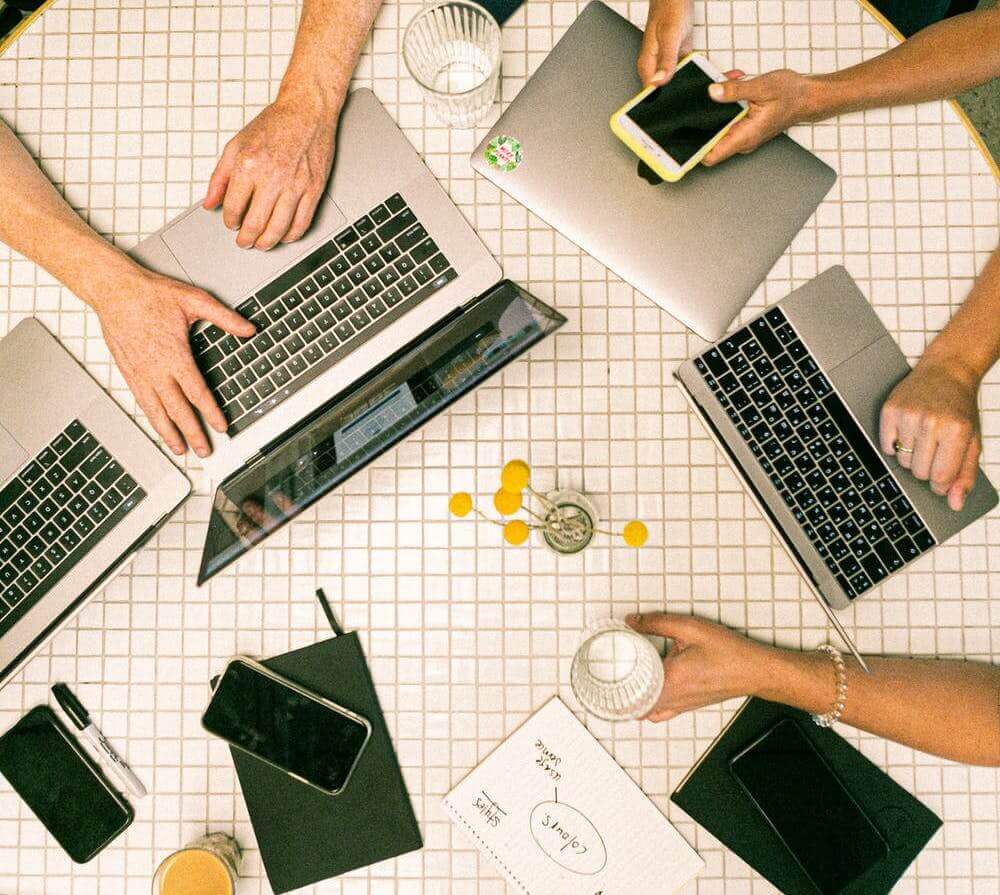 Business team working around a table with computers