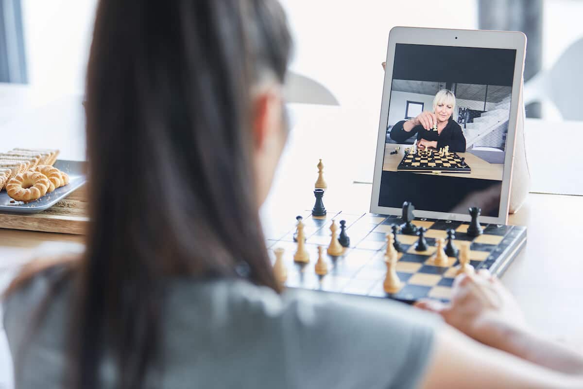 Two women playing chess over Zoom