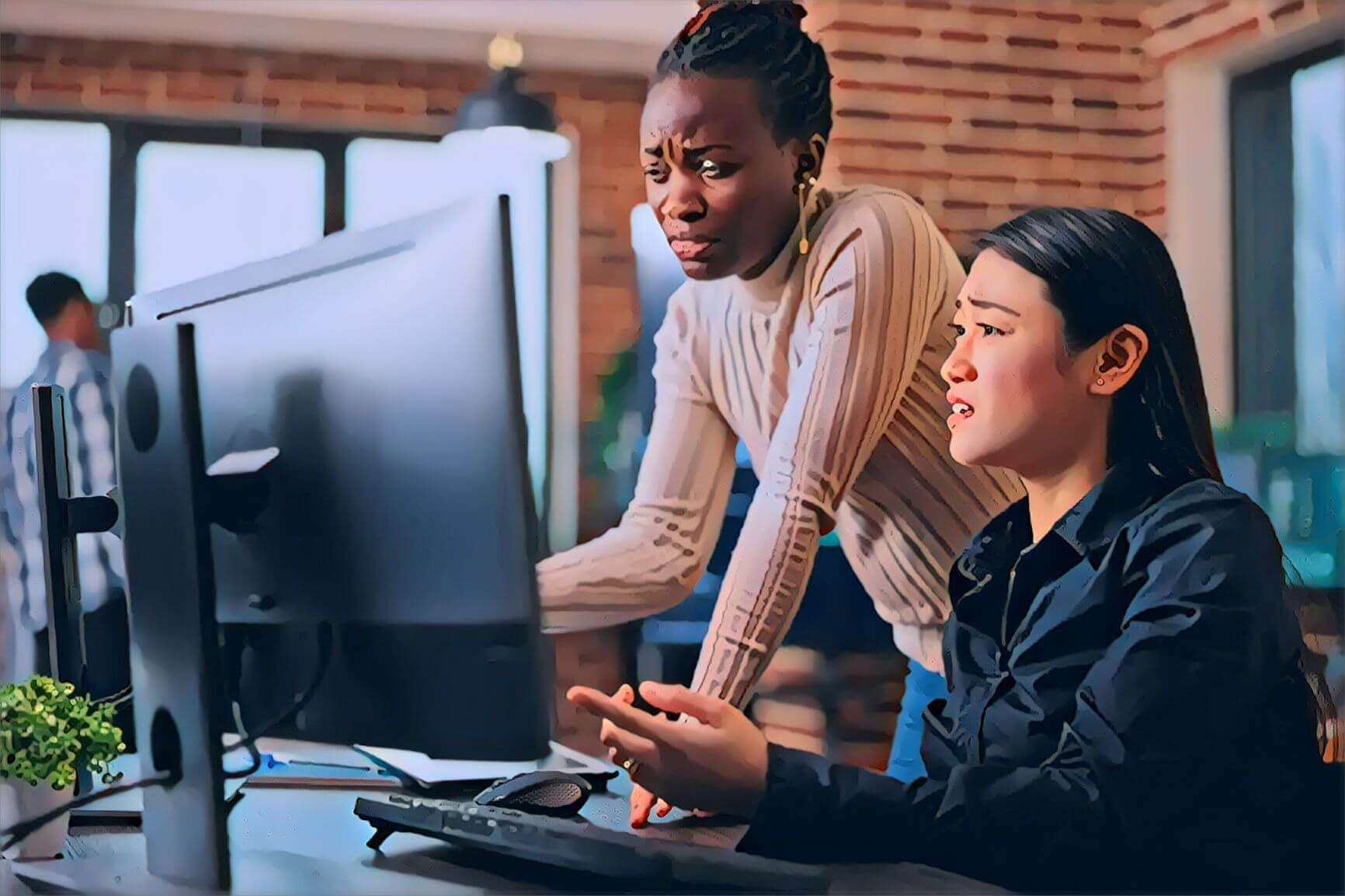 Two women in office looking at computer monitor wondering why their website isn't showing up in Google